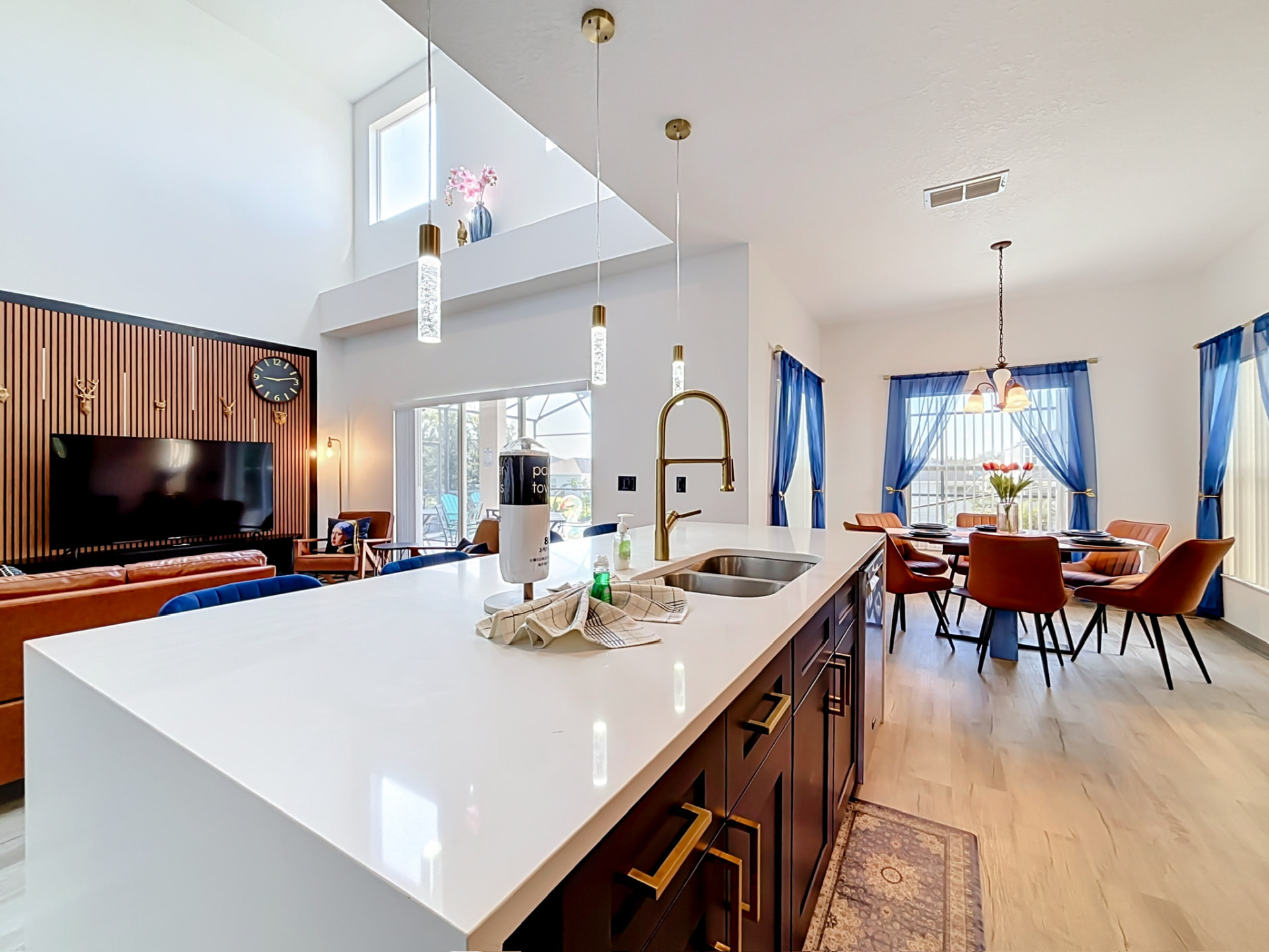 Open-plan view from the kitchen island to the dining and living areas