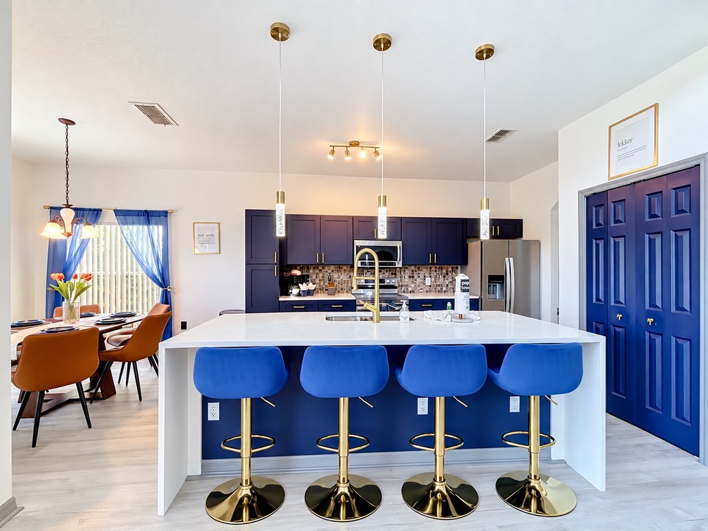 Remodeled kitchen with navy cabinetry and gold details